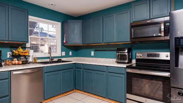 a kitchen with stainless steel appliances granite countertop a sink stove and microwave
