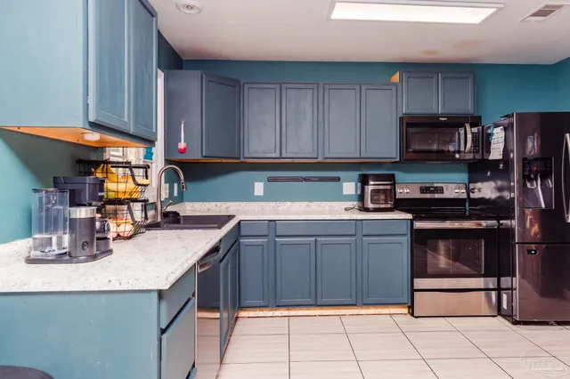 a kitchen with granite countertop a stove and cabinets