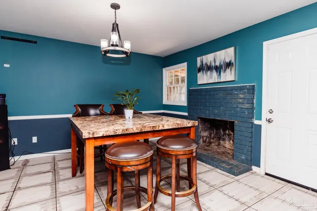 a dining room with a table and chairs