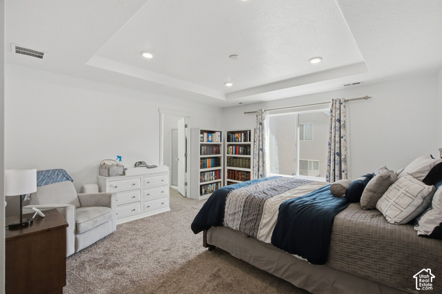 1113 South Raintree Lane Santaquin, UT 84655 - Photo 30 of 59 Tray ceiling with recessed lighting, integrated built-in shelving, sliding glass door, and neutral-toned carpeting