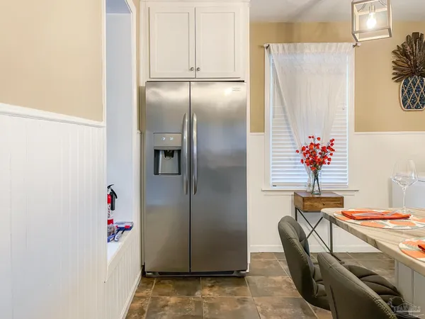 a view of a kitchen with a refrigerator and cabinets