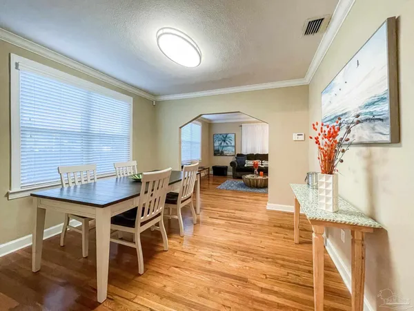 a view of a dining room with furniture and wooden floor