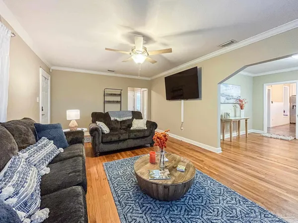 a living room with furniture and a flat screen tv