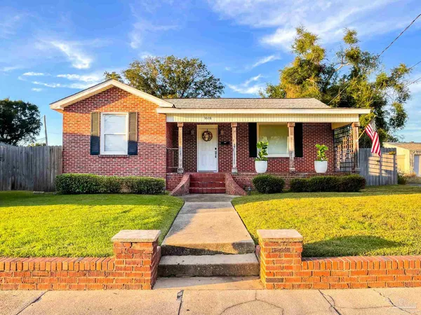 a view of a house with swimming pool and a yard
