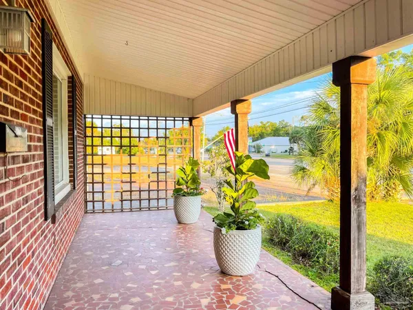 a view of a porch with furniture and garden