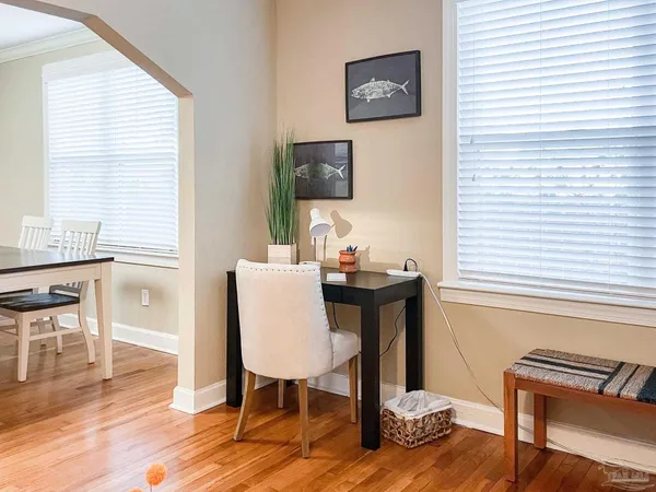 a view of a dining room with furniture window and wooden floor