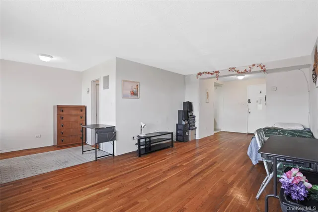 a bedroom with furniture and wooden floor