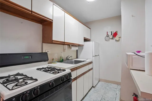 a kitchen with a stove and a refrigerator