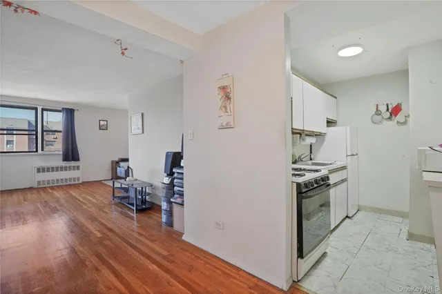 a kitchen with granite countertop a table chairs stove and cabinets