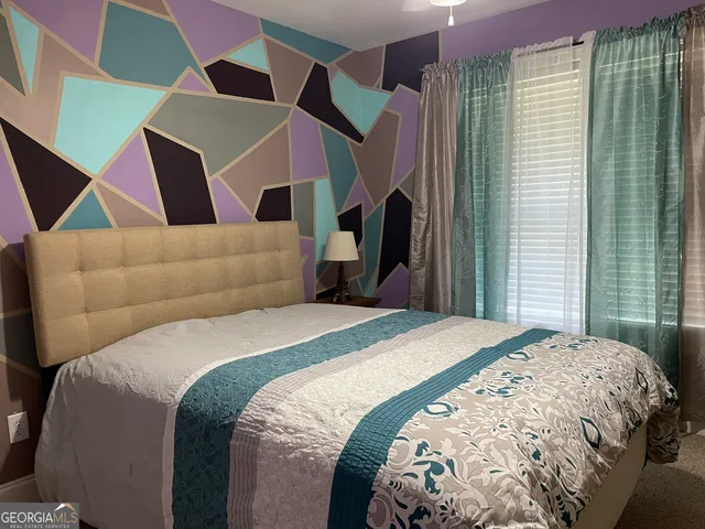 a bedroom with a bed and a mirror