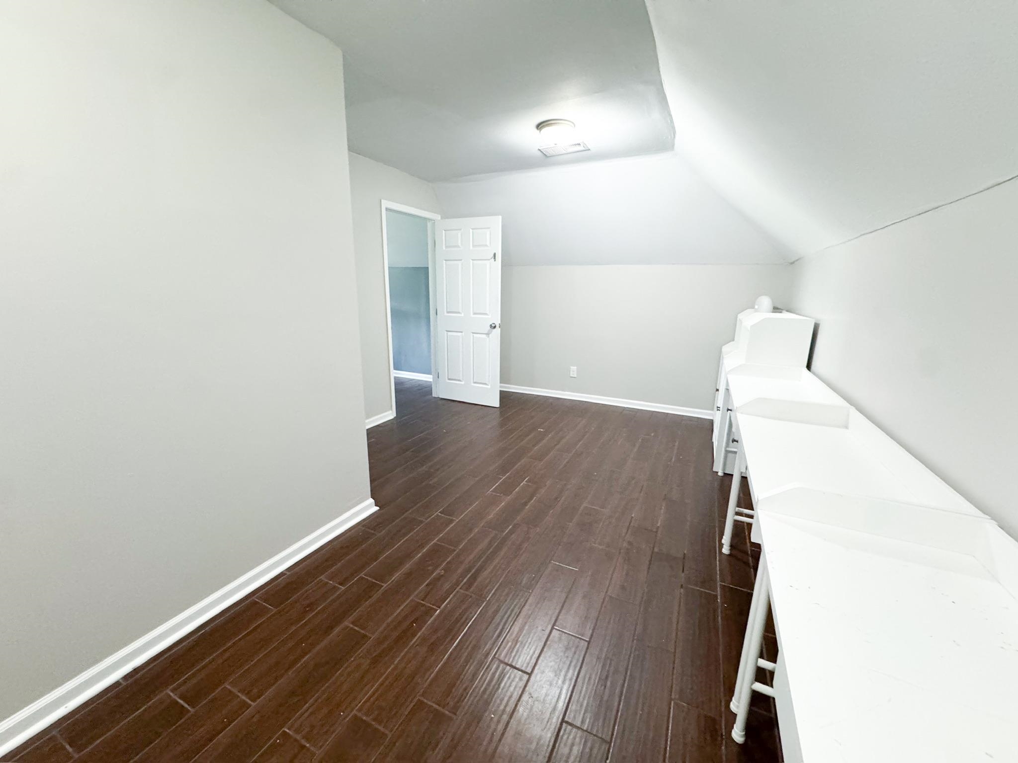 4776 Campground Road Munford, TN 38058 - Photo 17 of 25 an empty room with wooden floor cabinet and windows