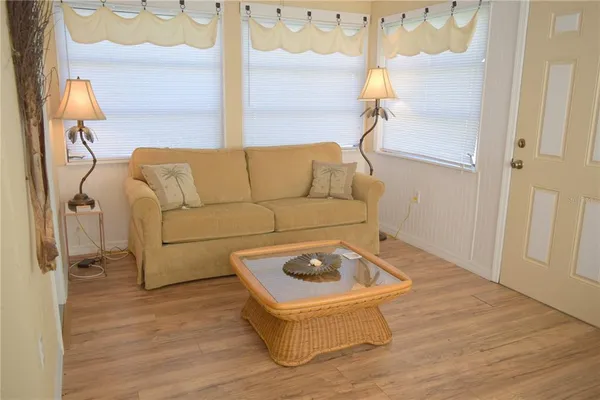 a living room with a couch and wooden floor
