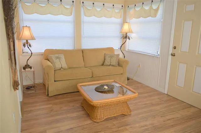 a living room with a couch and wooden floor