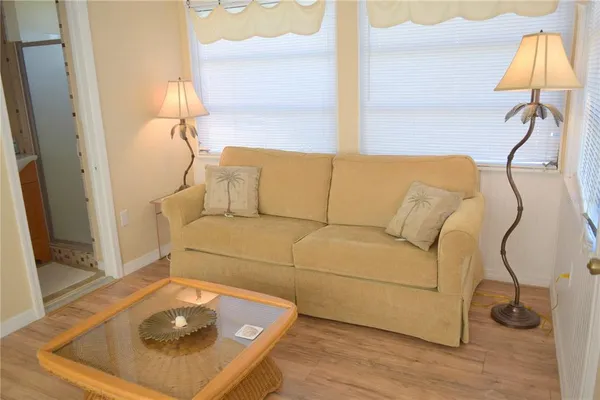 a living room with a couch and a table with wooden floor