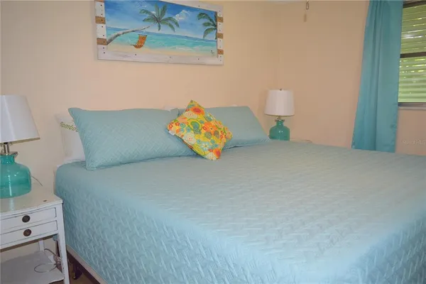 a bed sitting in a bedroom next to a window