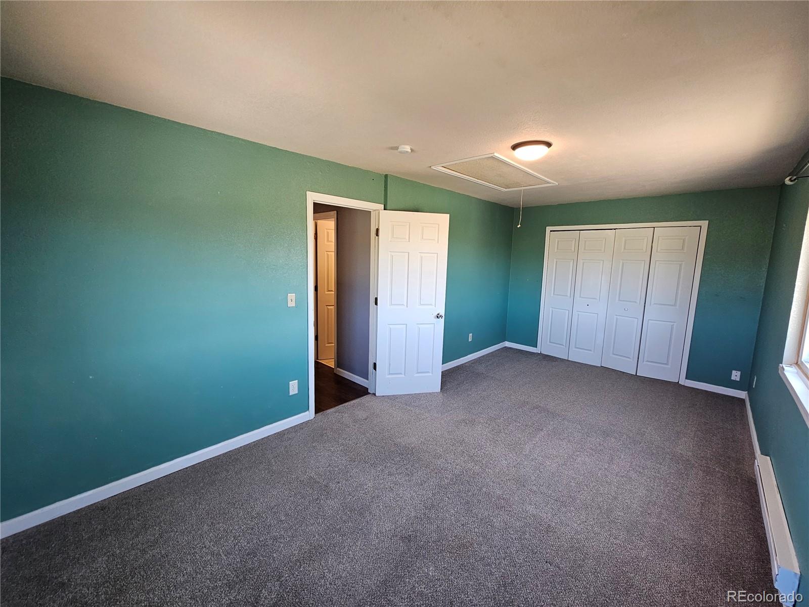 16985 Sage Crest Road Peyton, CO 80831 - Photo 19 of 25 an empty room with closet and wooden floor