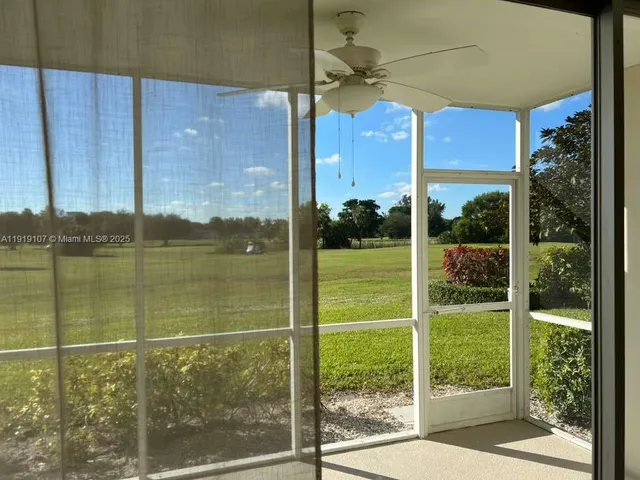 a view of a balcony with floor to ceiling windows with wooden floor