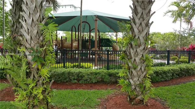 a view of park with swings and trees