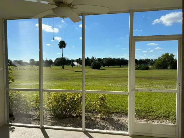 a view of a glass door and a yard