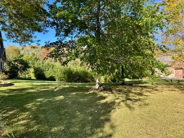 a view of outdoor space with swimming pool and green space