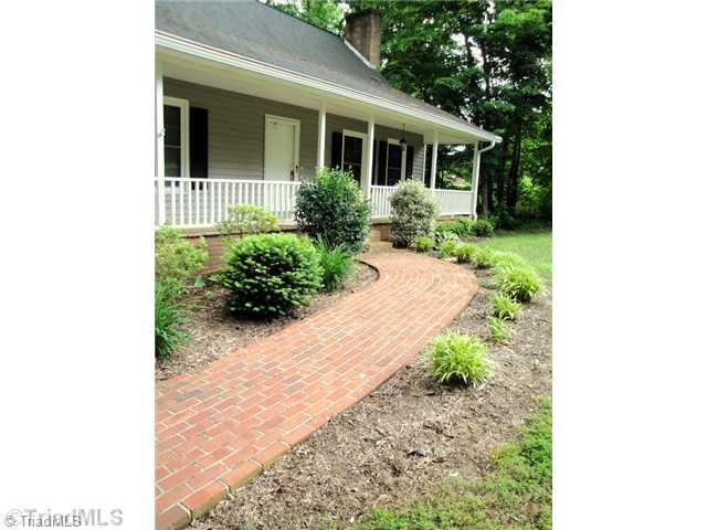398 Farmstead Road Winston-Salem, NC 27107 - Photo 2 of 16 Exterior Front. Brick paved sidewalk and beautiful retaining wall are just a few of the wonderful features of this home.
