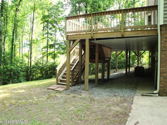 398 Farmstead Road Winston-Salem, NC 27107 - Photo 15 of 16 Patio/Deck. The deck has a gutter system in place to keep the area underneath dry...perfect for outdoor storage.
