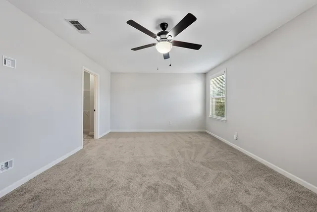 a bathroom with a granite countertop sink a toilet and shower