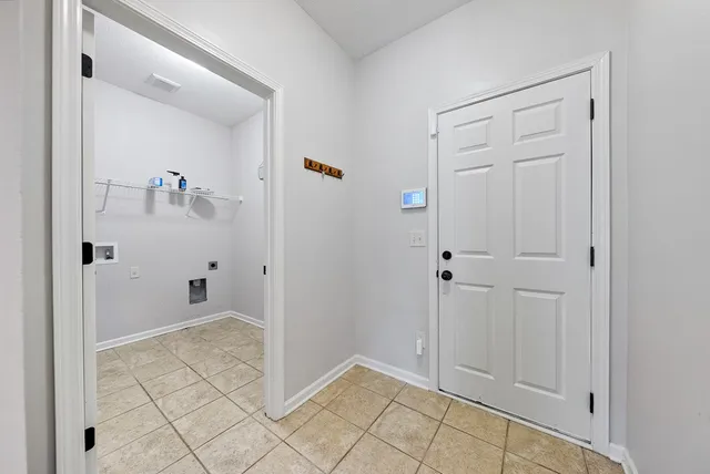 a view of a house with a wooden deck and a yard