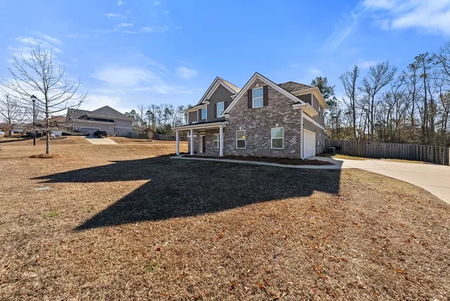 a front view of a house with a yard garage and outdoor seating
