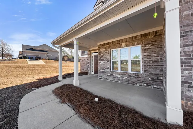 wooden floor in a hall with an entryway and a window