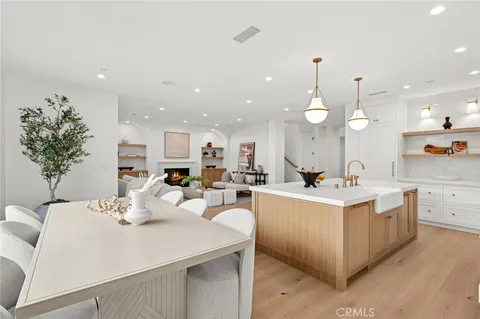 a large kitchen with kitchen island a sink appliances and a living room view