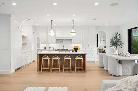 a large kitchen with a table and chairs