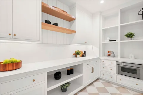 a kitchen with white cabinets and white appliances