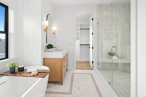 a bathroom with a tub sink and mirror