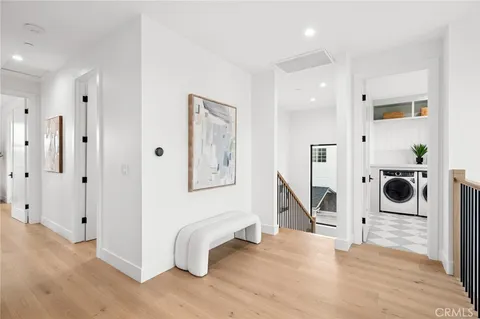 a view of entryway and hall with wooden floor