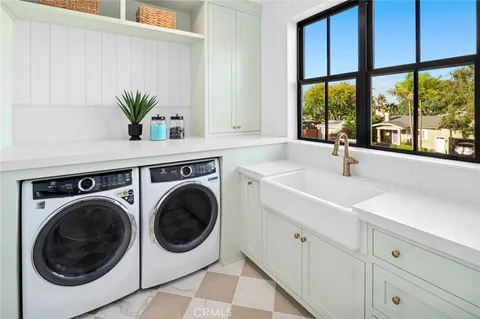 a utility room with sink dryer and washer