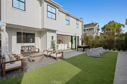 a view of a house with backyard porch and sitting area