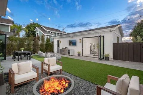 a view of an house with backyard and furniture