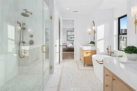 a bathroom with a tub sink shower and mirror