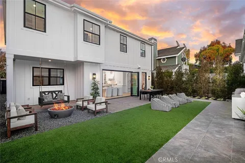 a front view of a house with garden and sitting area