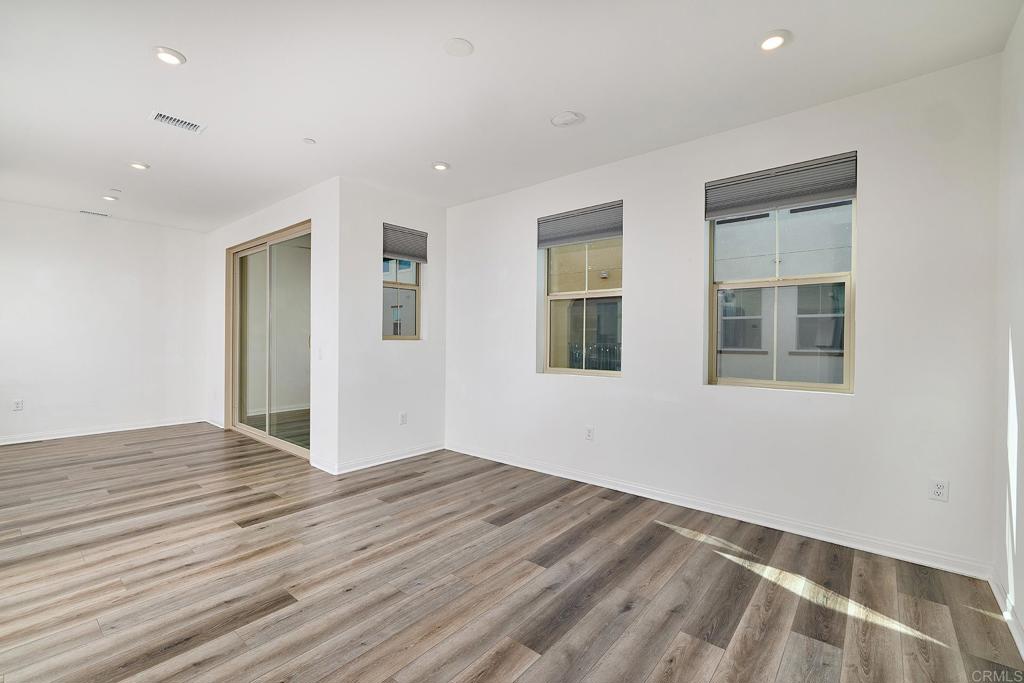 1622 Fig Tree Way Oceanside, CA 92056 - Photo 11 of 48 a view of an empty room with wooden floor and a window