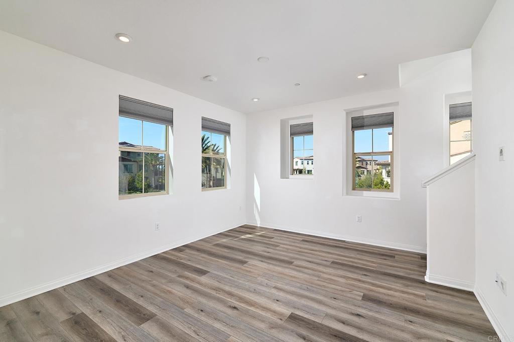 1622 Fig Tree Way Oceanside, CA 92056 - Photo 12 of 48 a view of an empty room with wooden floor and a window