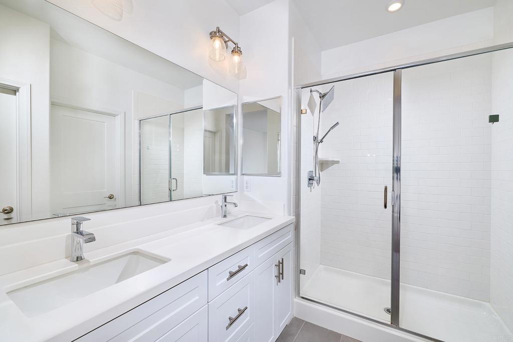 1622 Fig Tree Way Oceanside, CA 92056 - Photo 26 of 48 a bathroom with a double vanity sink mirror double and shower