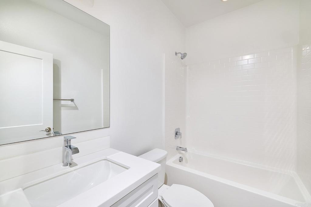 1622 Fig Tree Way Oceanside, CA 92056 - Photo 31 of 48 a bathroom with a bathtub sink vanity mirror and toilet