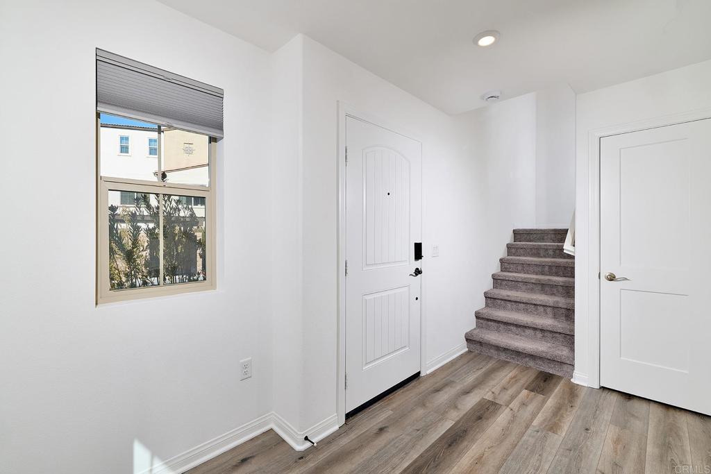 1622 Fig Tree Way Oceanside, CA 92056 - Photo 7 of 48 a view of a hallway with wooden floor and entryway