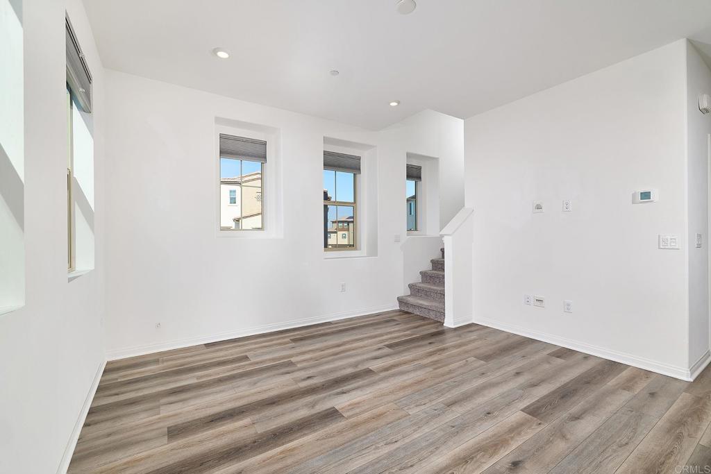 1622 Fig Tree Way Oceanside, CA 92056 - Photo 10 of 48 a view of empty room with wooden floor and fan