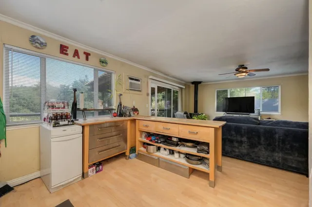 a large living room with stainless steel appliances kitchen island granite countertop furniture and a kitchen view