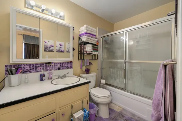 a roof deck with wooden floor and outdoor seating