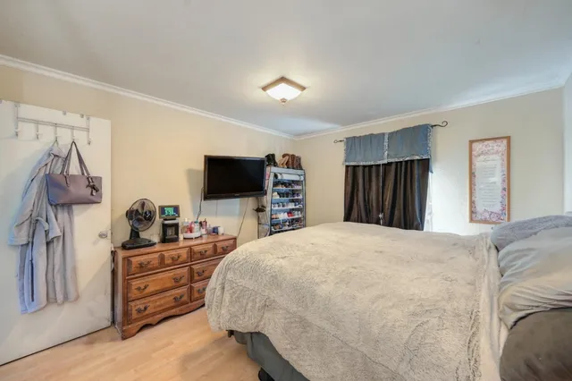 a bedroom with a bed and flat screen tv