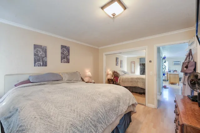 a bedroom with a large bed and a chandelier